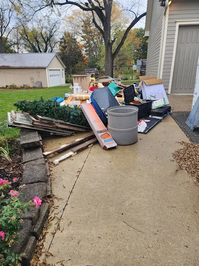 Dumpster being loaded with debris for Estate Cleanout Dumpster Rental in Lakewood Ranch